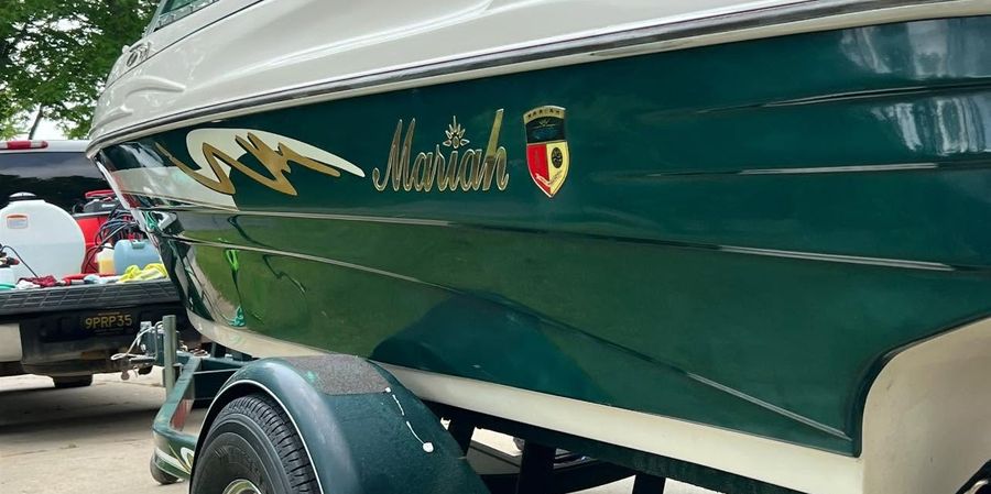 The same boat after oxidation removal, the green gel coat now deep and glossy