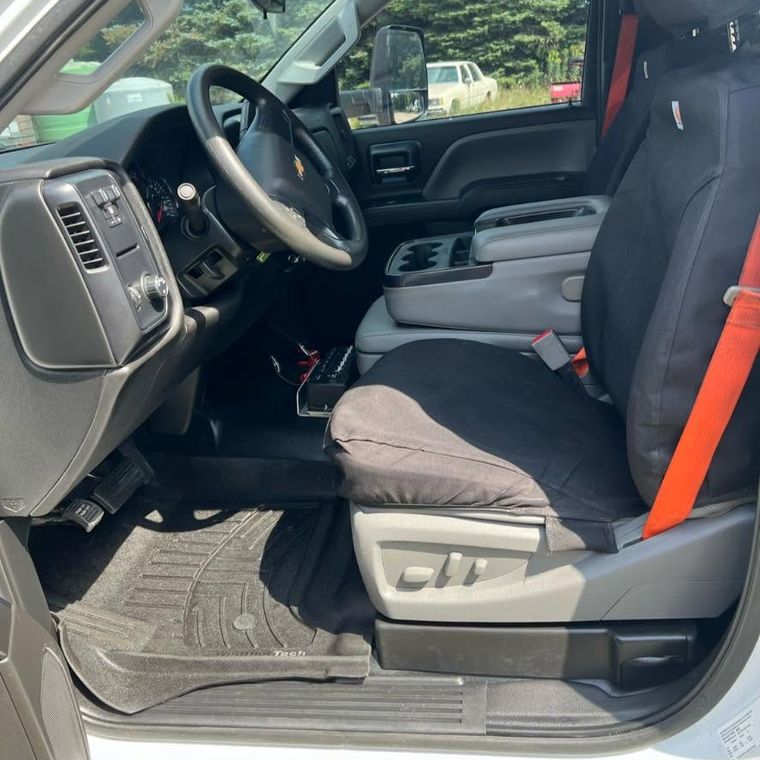 The same truck cab after an interior detail, with clean carpet, mats and seats