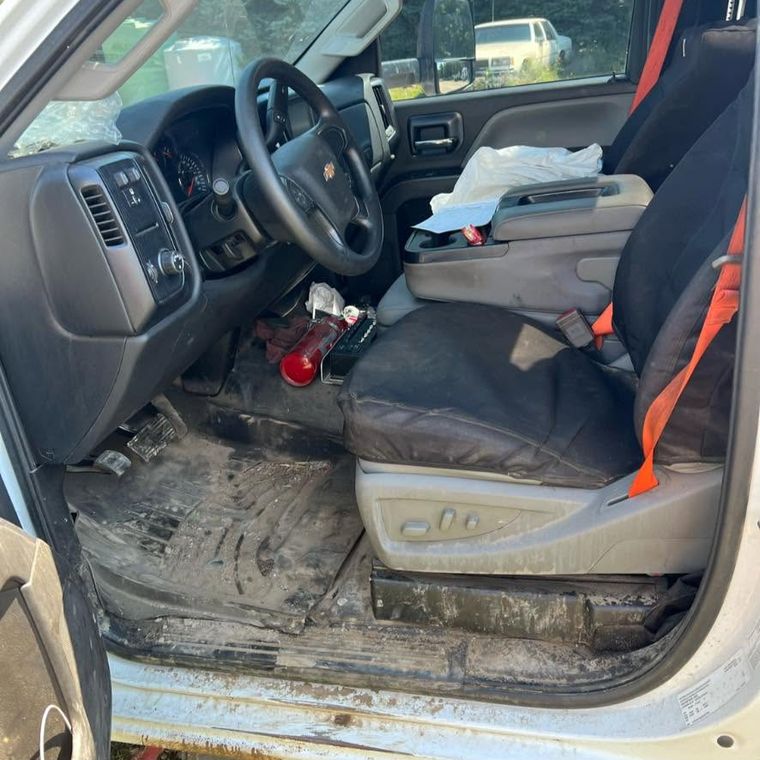 Truck cab interior with the floor caked in dried mud and dirt before an interior detail