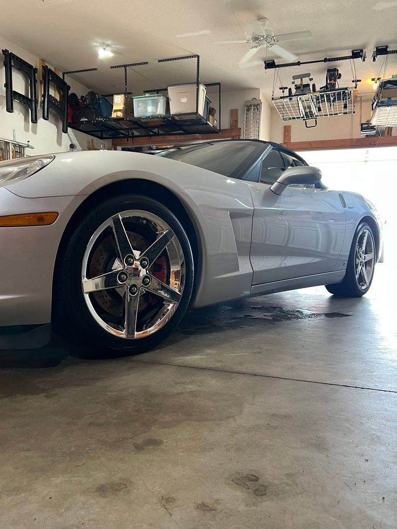 Silver Chevrolet Corvette detailed in a home garage